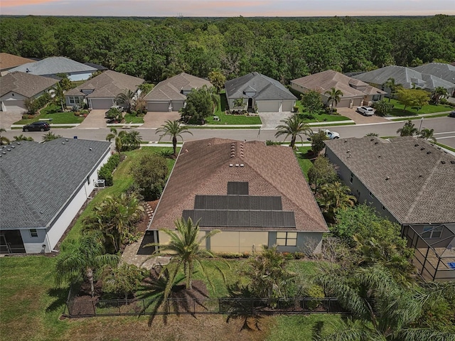 birds eye view of property featuring a wooded view and a residential view