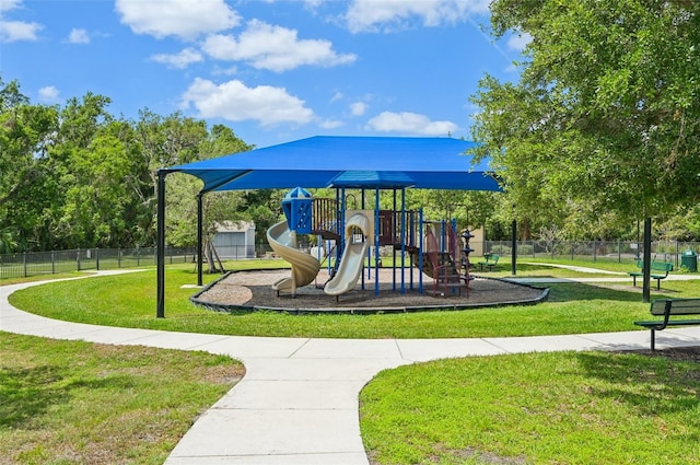 community play area with a yard and fence