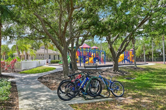 community playground featuring fence and a lawn
