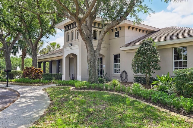 view of front of house featuring a tiled roof and stucco siding