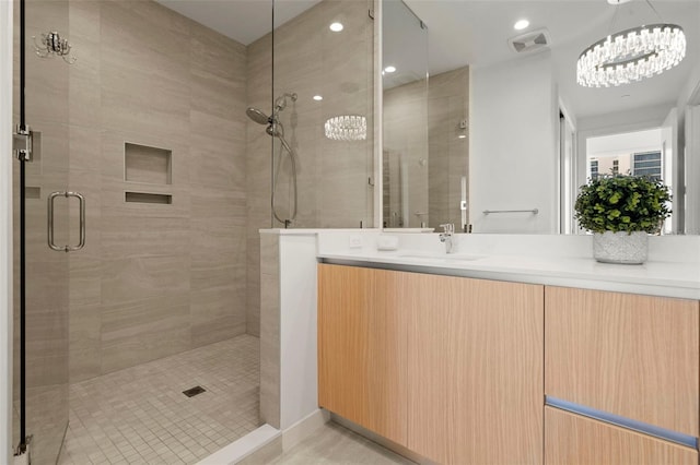 301 Quay Commons Unit 507, Sarasota, FL 34236 - bathroom featuring a stall shower and vanity