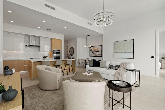 301 Quay Commons Unit 507, Sarasota, FL 34236 - living area featuring a chandelier, recessed lighting, and baseboards