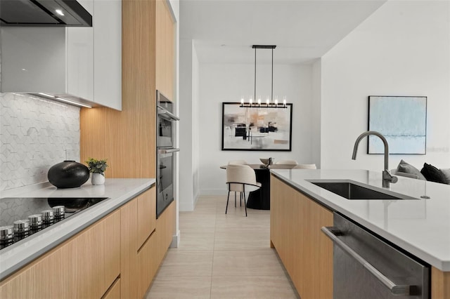 301 Quay Commons Unit 507, Sarasota, FL 34236 - kitchen with modern cabinets, a sink, stainless steel appliances, backsplash, and light tile patterned floors