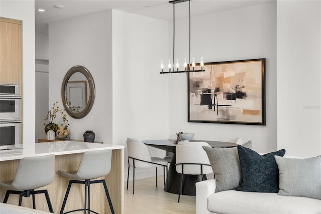 301 Quay Commons Unit 507, Sarasota, FL 34236 - dining area with light wood-style floors, a chandelier, baseboards, and recessed lighting