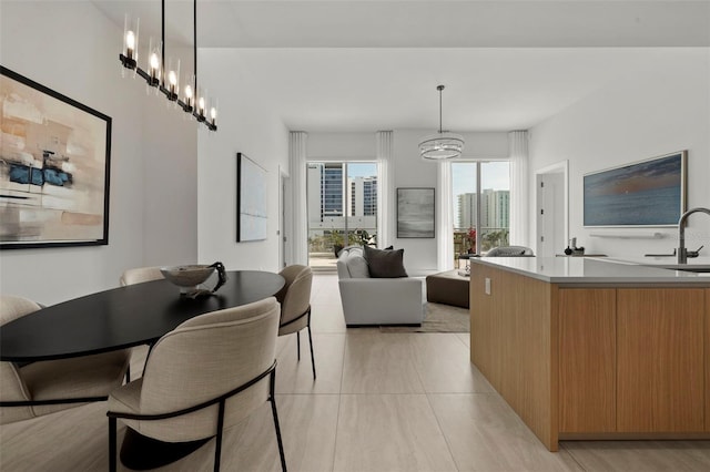 301 Quay Commons Unit 507, Sarasota, FL 34236 - dining area with a chandelier and light tile patterned floors