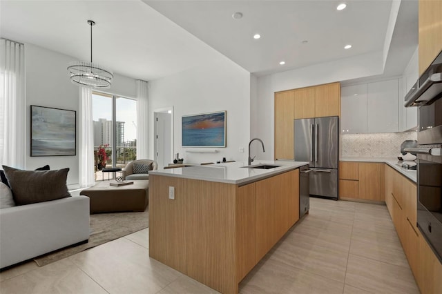 301 Quay Commons Unit 507, Sarasota, FL 34236 - kitchen with appliances with stainless steel finishes, modern cabinets, open floor plan, a sink, and recessed lighting