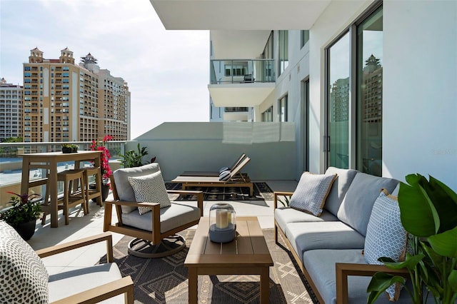 301 Quay Commons Unit 507, Sarasota, FL 34236 - balcony featuring outdoor lounge area
