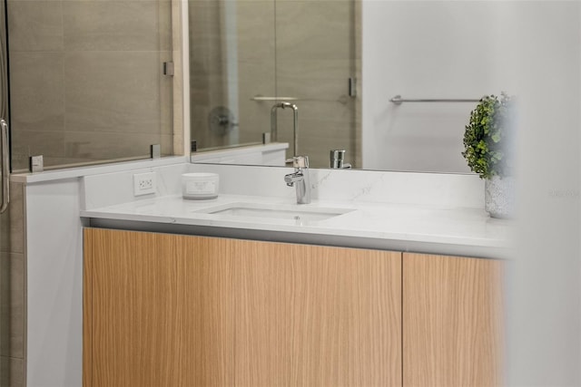 301 Quay Commons Unit 507, Sarasota, FL 34236 - bathroom featuring vanity and a shower with door