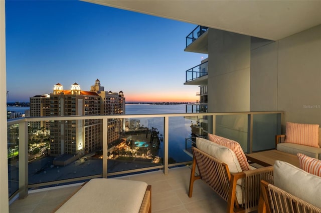 301 Quay Commons Unit 1610, Sarasota, FL 34236 - balcony at dusk featuring a water view