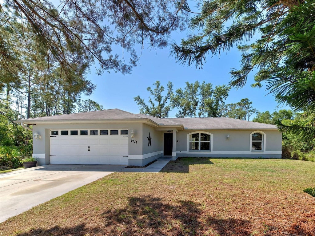 4777 Sunburst Ave, North Port, FL 34286 - single story home with a front yard, concrete driveway, a garage, and stucco siding