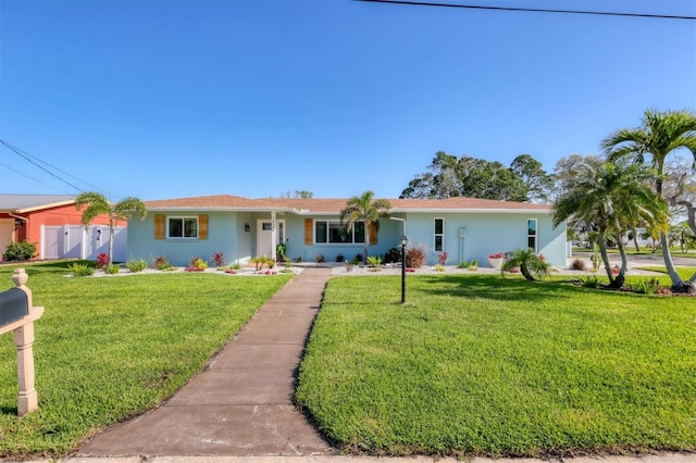 10304 Sandpiper Rd W, Bradenton, FL 34209 - ranch-style home featuring a front lawn and stucco siding