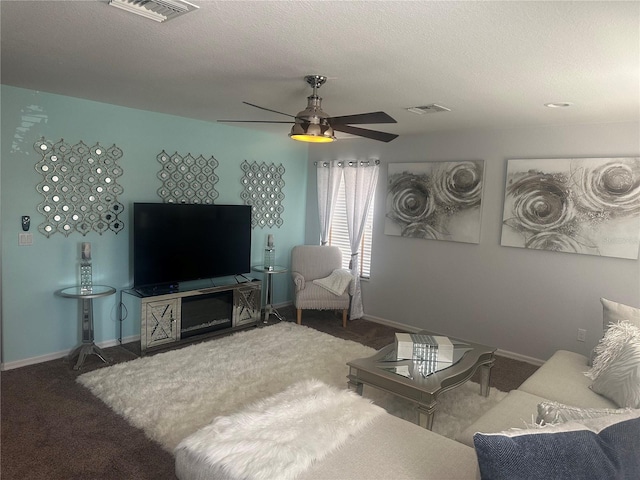 carpeted living room with baseboards, visible vents, and ceiling fan