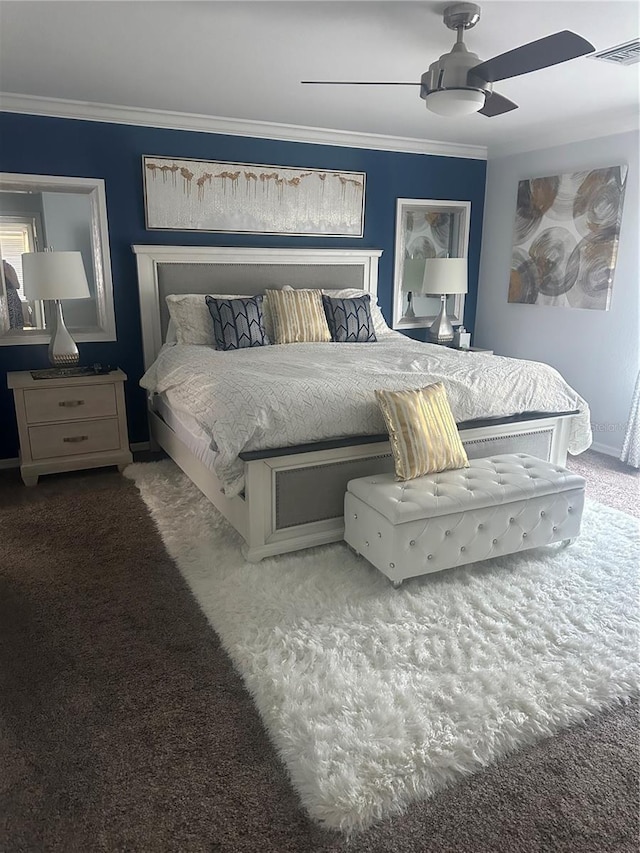 carpeted bedroom featuring a ceiling fan, baseboards, ornamental molding, and visible vents