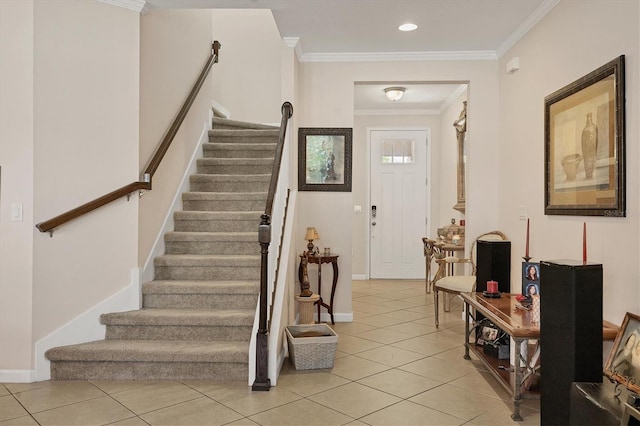 entryway with crown molding, light tile patterned floors, stairway, and baseboards