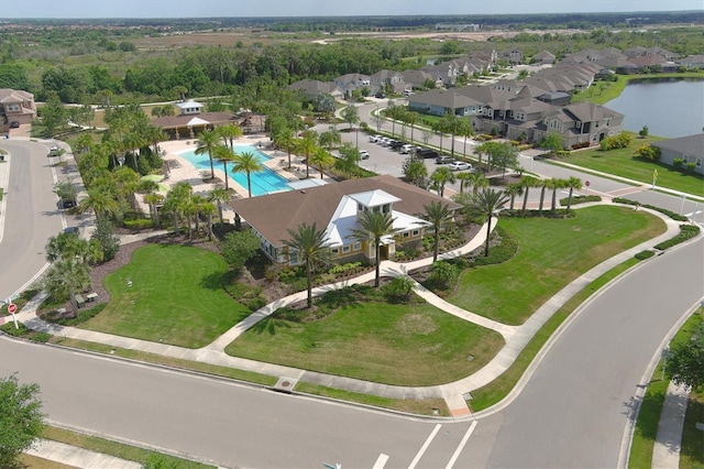 drone / aerial view featuring a water view and a residential view