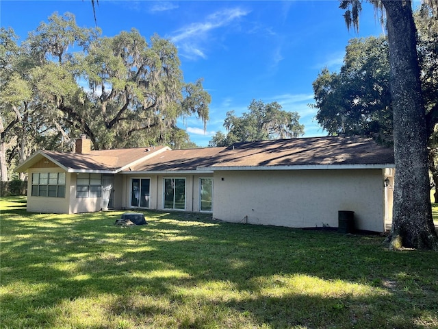 3 Lakeside Dr, Ocala, FL 34482 - rear view of house with a lawn and a chimney
