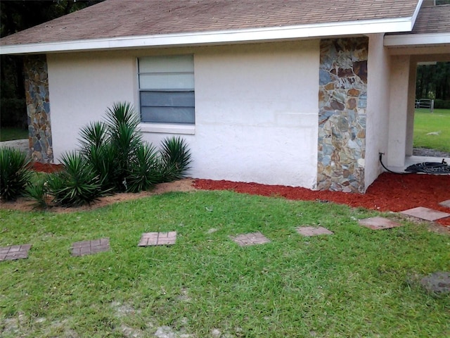 3 Lakeside Dr, Ocala, FL 34482 - view of side of home featuring stone siding, a yard, and stucco siding