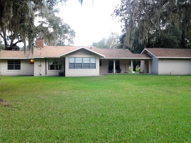 3 Lakeside Dr, Ocala, FL 34482 - back of house featuring a chimney and a yard