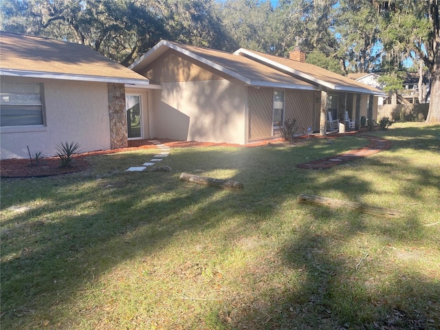 3 Lakeside Dr, Ocala, FL 34482 - view of property exterior with a yard, a chimney, and stucco siding