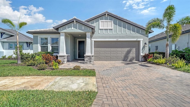 4725 Antrim Dr, Sarasota, FL 34240 - craftsman house featuring a garage, decorative driveway, board and batten siding, and stucco siding