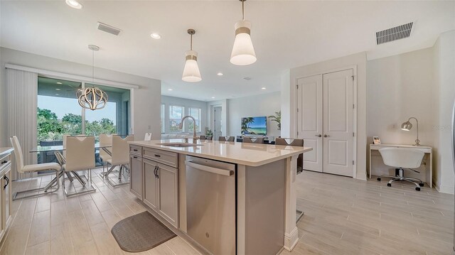 4725 Antrim Dr, Sarasota, FL 34240 - kitchen featuring dishwasher, a sink, light countertops, light wood-type flooring, and hanging light fixtures