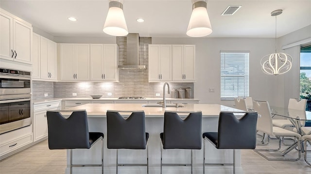 4725 Antrim Dr, Sarasota, FL 34240 - kitchen with wall chimney exhaust hood, a sink, light countertops, light wood-type flooring, and recessed lighting