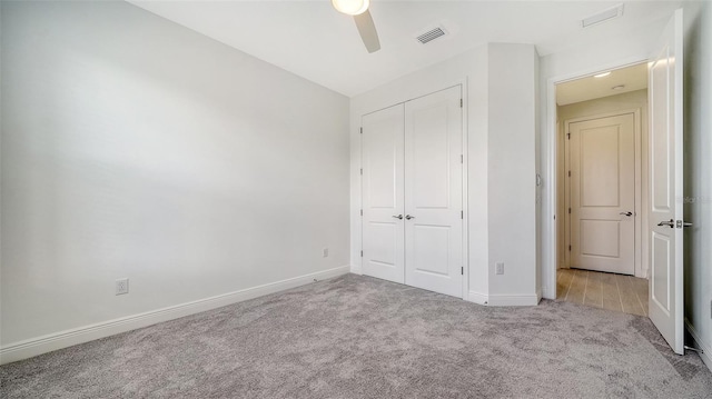 4725 Antrim Dr, Sarasota, FL 34240 - unfurnished bedroom featuring carpet, a closet, baseboards, and ceiling fan