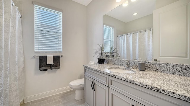 4725 Antrim Dr, Sarasota, FL 34240 - bathroom featuring baseboards, wood finished floors, toilet, vanity, and recessed lighting