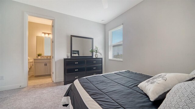 4725 Antrim Dr, Sarasota, FL 34240 - bedroom with light carpet, baseboards, and ensuite bathroom