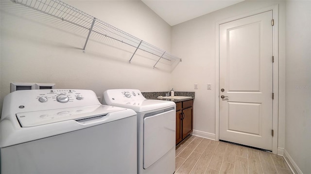 4725 Antrim Dr, Sarasota, FL 34240 - laundry room with independent washer and dryer, wood finish floors, baseboards, and cabinet space