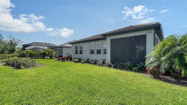 4725 Antrim Dr, Sarasota, FL 34240 - back of property with stucco siding, a lawn, and a lanai