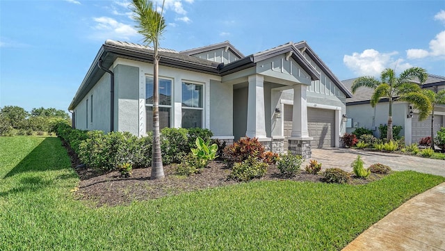 4725 Antrim Dr, Sarasota, FL 34240 - view of front facade featuring a garage, a front lawn, driveway, and stucco siding