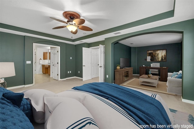 bedroom featuring arched walkways, baseboards, and carpet flooring