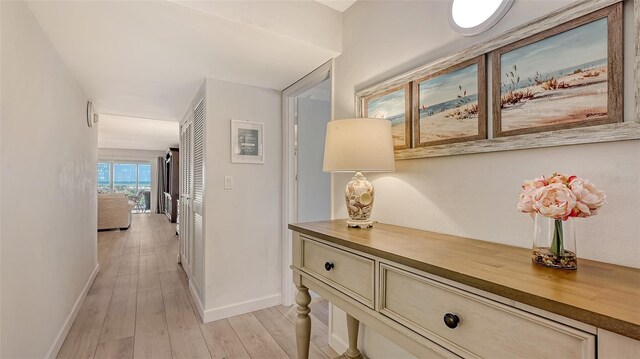 6951 Gulf Of Mexico Dr Unit 14, Longboat Key, FL 34228 - corridor with baseboards and light wood finished floors