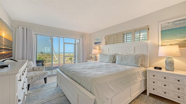 6951 Gulf Of Mexico Dr Unit 14, Longboat Key, FL 34228 - bedroom with access to exterior and multiple windows