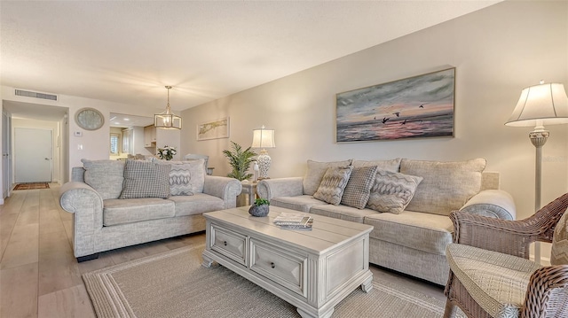 6951 Gulf Of Mexico Dr Unit 14, Longboat Key, FL 34228 - living area featuring visible vents and light wood-style floors