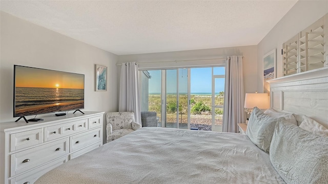 6951 Gulf Of Mexico Dr Unit 14, Longboat Key, FL 34228 - bedroom with access to exterior and a textured ceiling
