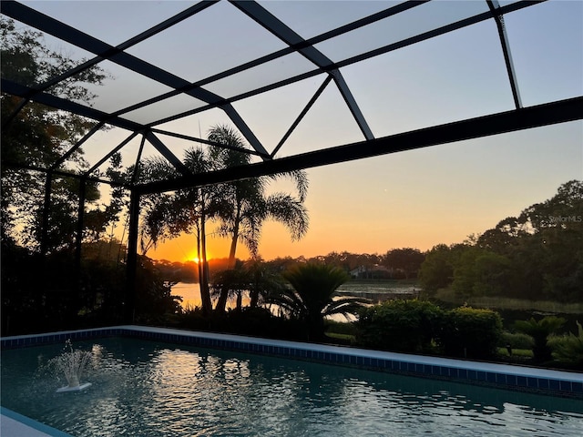 8687 Woodbriar Dr, Sarasota, FL 34238 - pool at dusk with an outdoor pool and glass enclosure