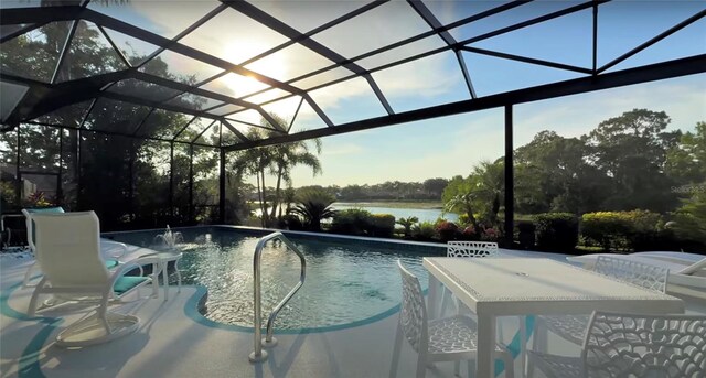 8687 Woodbriar Dr, Sarasota, FL 34238 - swimming pool featuring glass enclosure, a patio area, and a water view