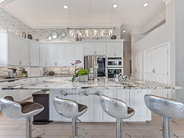 8687 Woodbriar Dr, Sarasota, FL 34238 - kitchen with appliances with stainless steel finishes, ornamental molding, backsplash, a breakfast bar, and recessed lighting