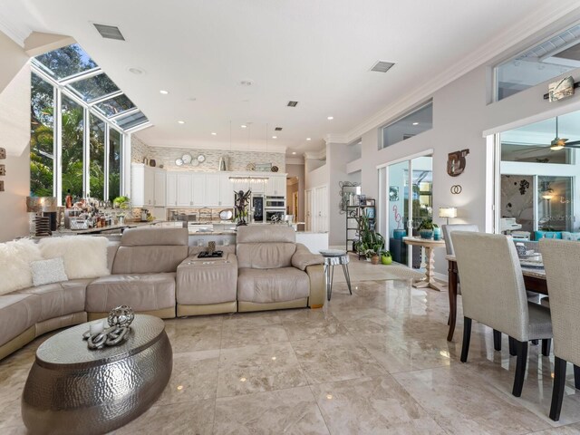8687 Woodbriar Dr, Sarasota, FL 34238 - living area with plenty of natural light, crown molding, a towering ceiling, a ceiling fan, and recessed lighting