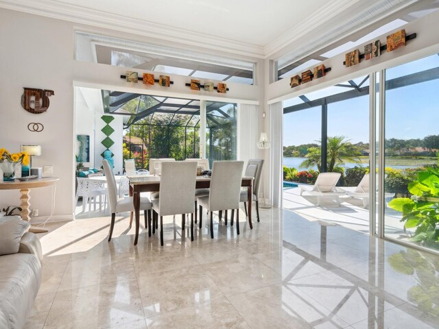 8687 Woodbriar Dr, Sarasota, FL 34238 - dining area with crown molding, light marble finish flooring, a water view, and a sunroom