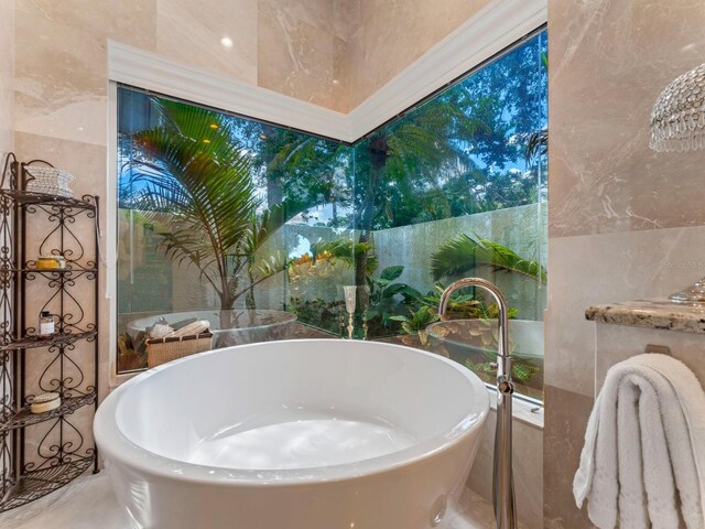 8687 Woodbriar Dr, Sarasota, FL 34238 - full bath featuring a freestanding bath and tile walls