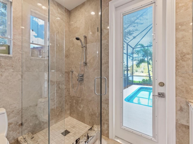 8687 Woodbriar Dr, Sarasota, FL 34238 - bathroom featuring a stall shower and toilet