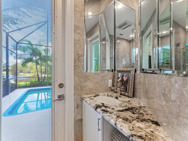 8687 Woodbriar Dr, Sarasota, FL 34238 - bathroom featuring vanity and a shower with door