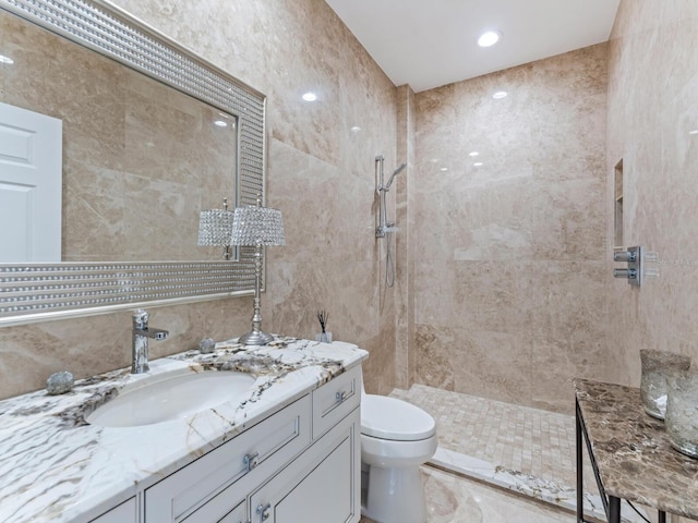 8687 Woodbriar Dr, Sarasota, FL 34238 - bathroom with toilet, a tile shower, tile walls, and vanity