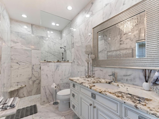 8687 Woodbriar Dr, Sarasota, FL 34238 - bathroom featuring tile walls, marble finish floors, a marble finish shower, vanity, and toilet