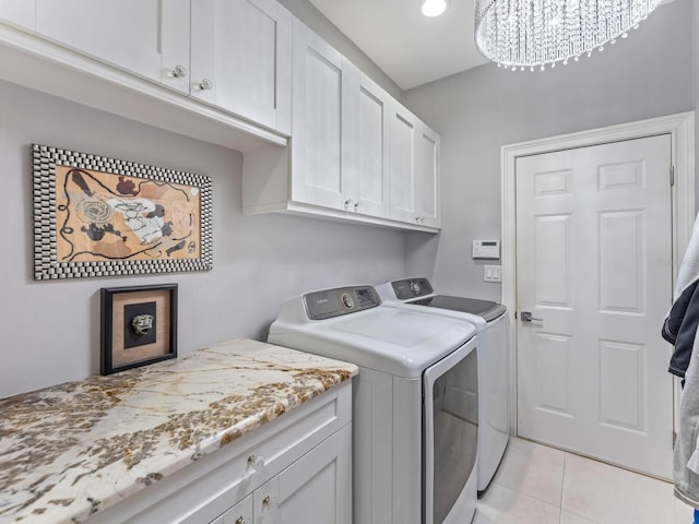 8687 Woodbriar Dr, Sarasota, FL 34238 - clothes washing area with cabinet space, washing machine and clothes dryer, and light tile patterned flooring