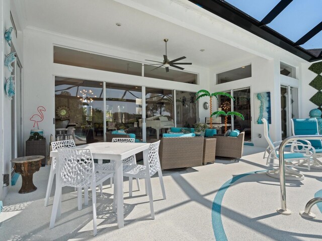 8687 Woodbriar Dr, Sarasota, FL 34238 - view of patio / terrace with a ceiling fan, an outdoor hangout area, glass enclosure, and outdoor dining space