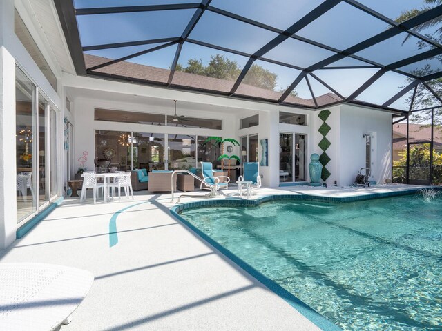 8687 Woodbriar Dr, Sarasota, FL 34238 - outdoor pool featuring a patio area, ceiling fan, glass enclosure, and an outdoor living space